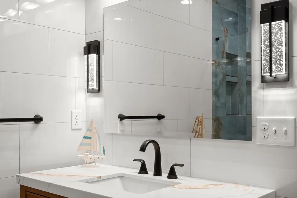White wall tile, black fixtures and wall sconces